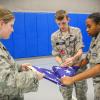 A trio of cadets trains their eyes and hands on an important task: properly folding Old Glory. 