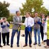 Student entrepreneur Jason Wiedl shakes hands with Penn College President Michael J. Reed, among the campus and community dignitaries on hand for the ribbon-cutting.