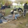 As students wield floats and a screed board, DiBucci (in blue shirt) supervises the busy crew.