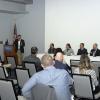 Michael Melone (left), a public sector security consultant and senior cybersecurity adviser, moderates the panel discussion in the PDC. Seated (from left) are Monteleone, Potter, Wood, Brown and Hall.