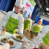 Noah W. Beck, of Port Matilda, graduating Dec. 16 with an associate degree in culinary arts technology, hands a plate to judges during the Student Cooking Challenge at the 2023 Pennsylvania Farm Show.