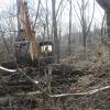 Undaunted by rough terrain within Penn's Woods, Andrew P. Keister, laboratory assistant for diesel equipment technology, clears felled trees and brush at the eventual site of Baja SAE Williamsport.