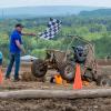 checkered flag being waved as Baja car crosses finish line