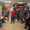 A group gathers near thermoforming equipment