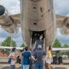 campers looking at large plane