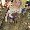 child playing in mud