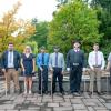 eight individuals pose after training graduation ceremony