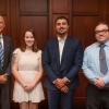 college president poses with three top award winners