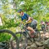 cyclist riding over rocks