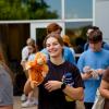 student holding stuffed animal