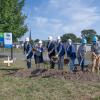 a group breaks ground with shovels