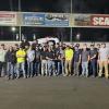 team gathers with trophy