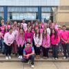 large group of club members dressed in pink