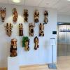 wooden masks on display in gallery lobby