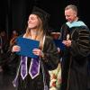 graduate on the stage with her diploma