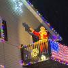 Santa waving from a house porch