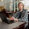 Dalton R. Neece at a laptop in the college's library