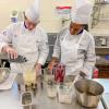 two culinary students working in a lab