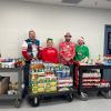 four individuals with carts of food