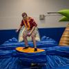 James C. Fretz, a construction management student from Collegeville, is one of the sure-footed souls ridin' the waves on a simulated surfboard.