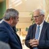 Always engaged and advocating for the college, Yaw (right) converses with Browne in the atrium of the Breuder Advanced Technology & Health Sciences Center. 