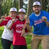 From left, Sarah S. Moore, Travis Mikulka and Korey T. Keyser sign "L," "L," and "W.S." for Little League World Series during their "awesome" weekend of teamwork.