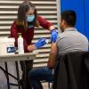 Kendra F. Boell, physician assistant instructor, administers a vaccine to Miguel A. Callado, a construction management student residing in Williamsport. 