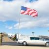 Wind-swept flag snaps to attention for patriot's final parade