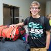 Hopeful tennis team member Joseph H. Griep, an information technology sciences: gaming and simulation freshman from Le Roy, New York, moves his gear into Dauphin Hall.