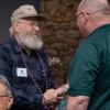 Denice Palmeter, '59, electronics, proudly wears his honor cord while exchanging sincere appreciation with Beaver.