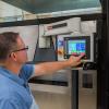 Christopher J. Gagliano, program manager for Penn College’s Thermoforming Center of Excellence, operates the new equipment.