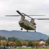 Against a fall-colored backdrop, the Chinook lands outside the library.