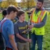 Penn College student Shawn L. Sheeley Jr., of Kersey, shows a high school student how to use surveying equipment. The hands-on workshop was part of a National STEM Day celebration at the college that brought homeschoolers and students from four area high schools to campus.