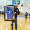 Aubrey Alexander accepts a framed #9 Wildcat jersey, representing his Penn College graduation year.