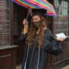 Stylin' in the rain is nursing's Caroline M. Engel, sporting a sparkly gold mask under a colorful umbrella. Engel received the Shirley Novosel Memorial Award, along with her bachelor's degree, during Saturday's commencement.