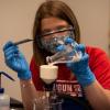 Focused on the task at hand, a camper makes aspirin in a chemistry lab.