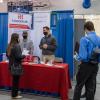 A typical scene at Pennsylvania College of Technology’s Career Fairs – alumni returning to recruit future workers. Here, Nicholas D. Tartaglia (at center under the “Alumni” banner), and his colleague (in hat), Thomas M. Whitehouse, discuss Harkins Builders, Inc. opportunities with a student, while two others wait their turn. Tartaglia and Whitehouse both earned Penn College associate degrees in building construction technology and bachelor’s degrees in residential construction technology and management.