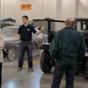 Sean M. Hunter, of Livingston, N.J., knowledgeably leads an AACA tour group through the College Avenue Labs automotive restoration facilities.