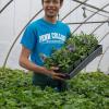 National “HortScholar” Aaron A. Sledge Jr., a May graduate in landscape/horticulture technology: plant production emphasis, welcomes Open House visitors to a Penn College greenhouse.