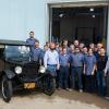 Aubrey Alexander (front row, left) and brother Adam (front row, right) deliver a 1926 Ford Model T to students and faculty outside College Avenue Labs, home to Penn College’s automotive restoration and collision repair majors.