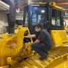 Students in Penn College’s heavy construction equipment technology program – like Jacob M. Speery (foreground), of York, and Ethan J. Svonavec (seated in cab), of Somerset – get to work with a Komatsu D51PX-24 crawler dozer, courtesy of an entrustment agreement with Anderson Equipment Co.