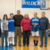 Lady Wildcats Kierstin Steer (second from left) and Mackenzie Brown join their parents at midcourt for Senior Day recognition.