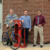 Part of the successful community effort to have Pennsylvania College of Technology categorized as “Bicycle Friendly,” three college employees gather at the bike storage room and repair station outside Dauphin Hall. From left are D. Robert Cooley, associate professor of anthropology/environmental science; Anthony J. Pace, assistant dean of academic operations; and Chris E. Miller, Penn College Police chief and director of campus safety.