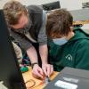 Engineering design student Stephen C. Brodecki, who’s also taking the Robotic Applications course, is among a pair of Penn College Eagle Scouts who lent hands-on help to scouts pursuing an electronics merit badge.