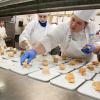 Culinary arts and systems students Sarae D. Davis (left), of Nescopeck, and Brianna R. Helmick, of Hershey, help to assemble a “trout napoleon” for the first course.