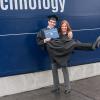 Never too old for a pick-me-up from Mom, Carlos A. Ramos-Sonera celebrates in front of the Penn College sign.