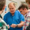 Students watch closely as Eric K. Albert, associate professor of machine tool technology/automated manufacturing, removes a magnetic 3-D creation from its “scaffold.”