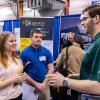 Plastics and polymer engineering technology students Cassie N. Shook, of Wesport, and Evan M. Prough, of Lock Haven, visit with a graduate of their major: B. Braun Medical Inc.'s Daniel M. Dietrich.