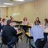 Groups – including the one in foreground, facilitated by Judy Quinti, assistant professor of exercise science – discuss a case in several rooms of the Bush Campus Center.