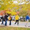 In colors coordinated with nature, a family tours campus with Ambassador Bryan M. Behm.